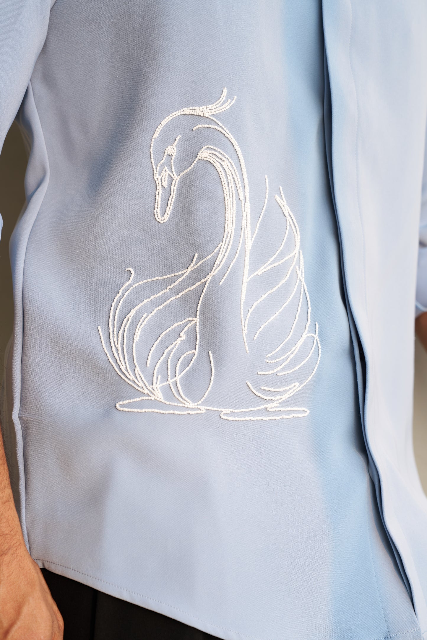 Light grey shirt with a white swan hand embroidery design