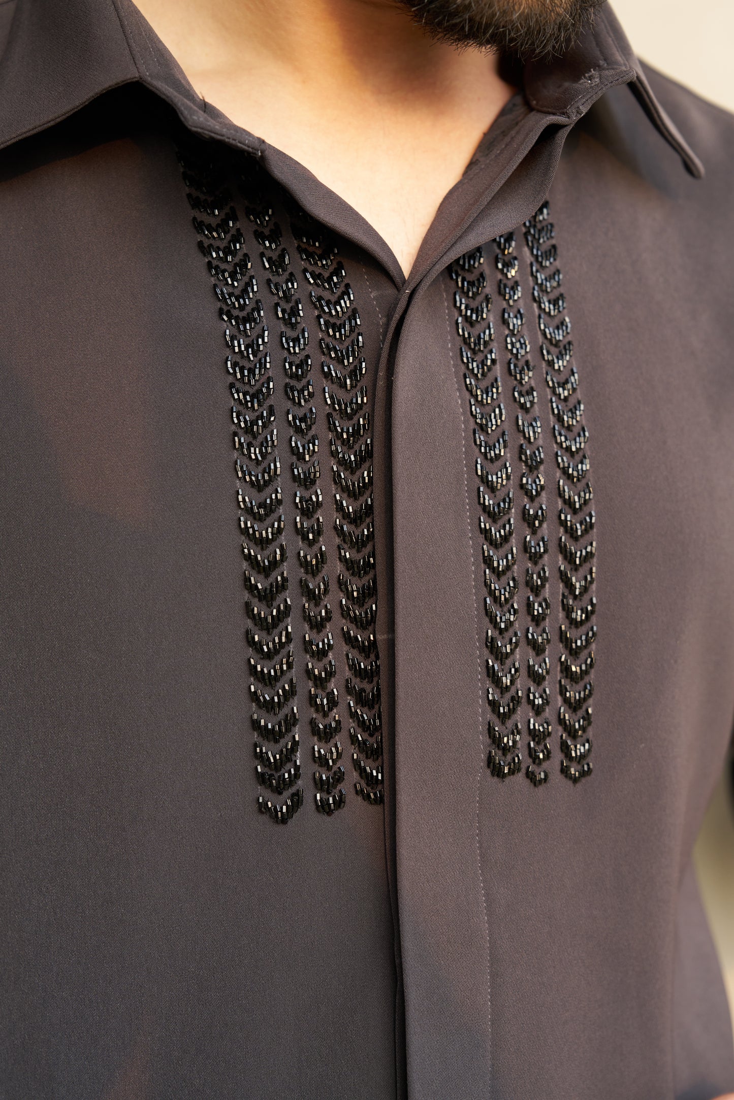 Dark grey shirt with black embellishment design