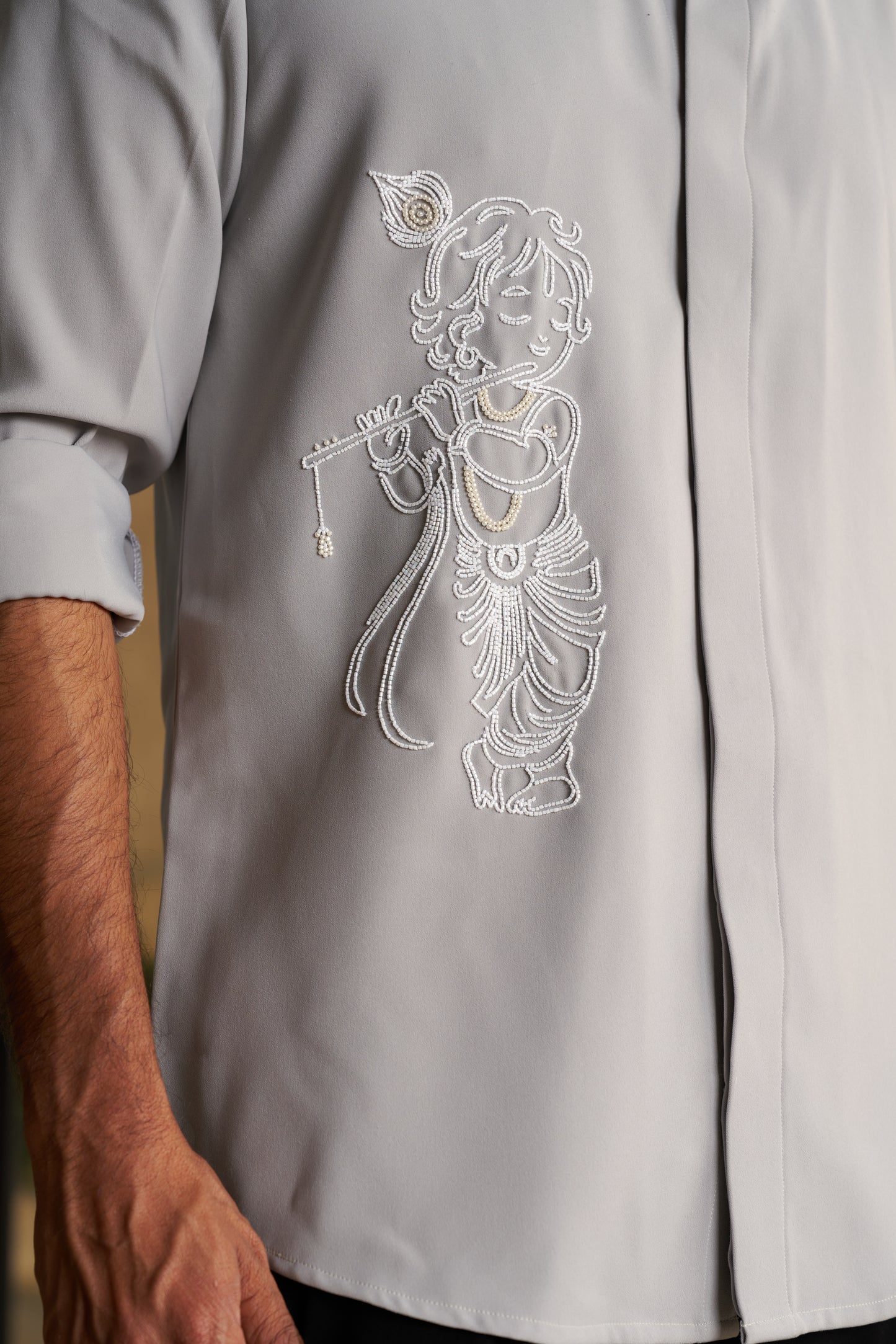 Light green shirt with Baby Krishna and flute hand embroidery design