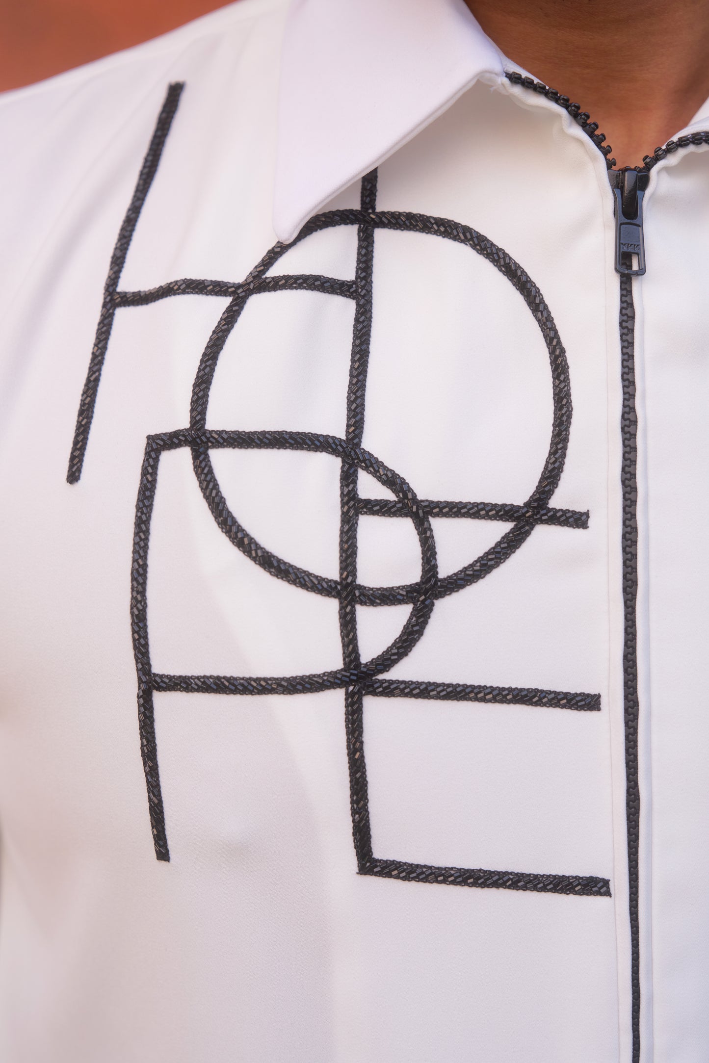 White shirt with Black geometric HOPE design in zipper model
