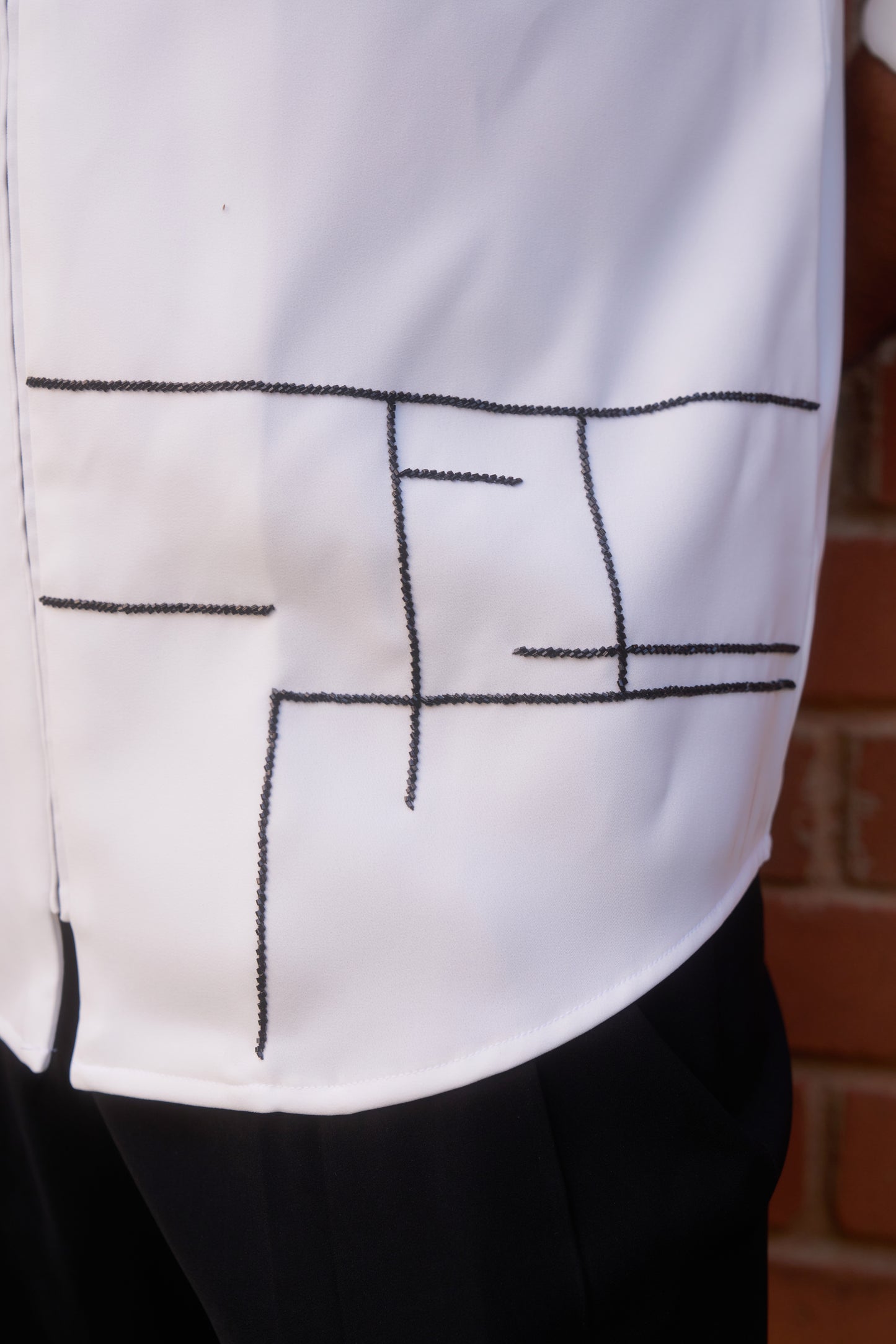 White shirt with Black geometric HOPE design in zipper model