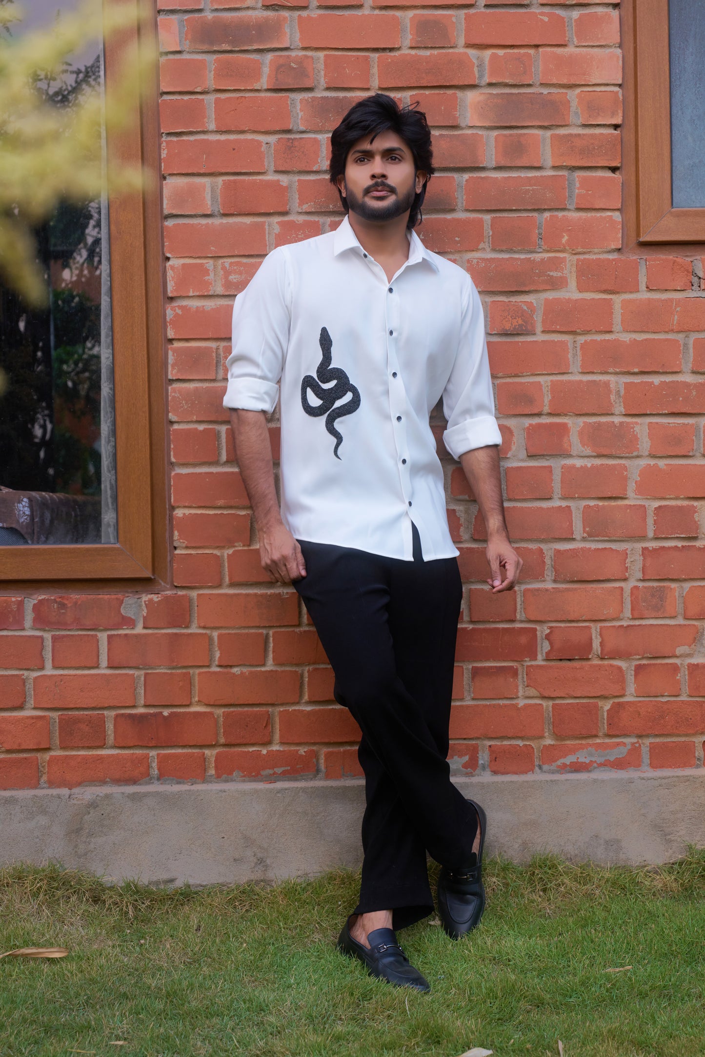 White shirt with a black snake hand embroidery design