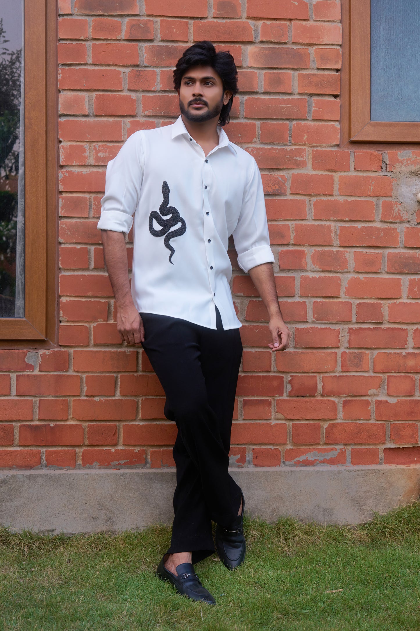 White shirt with a black snake hand embroidery design