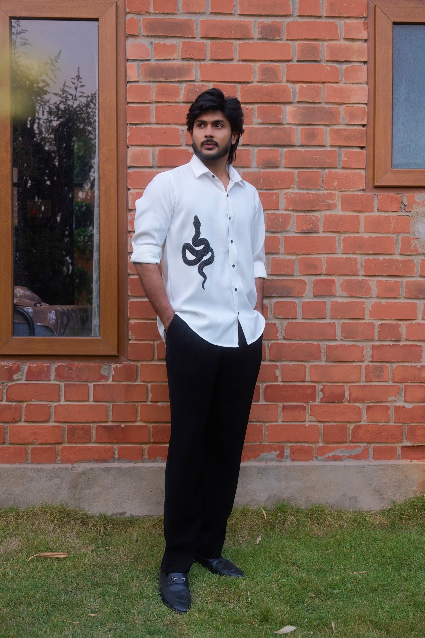 White shirt with a black snake hand embroidery design