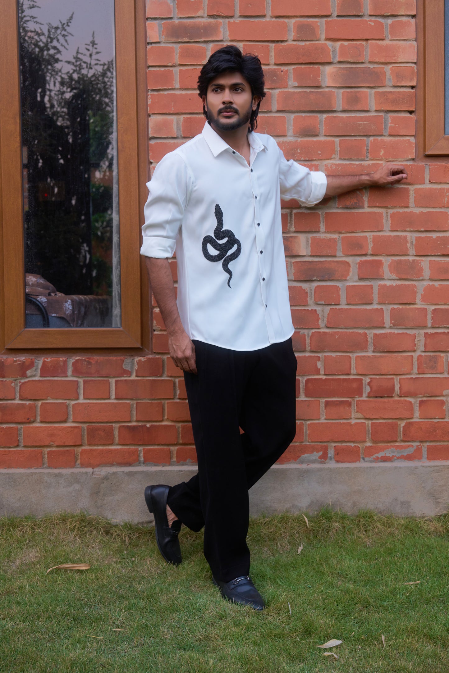 White shirt with a black snake hand embroidery design