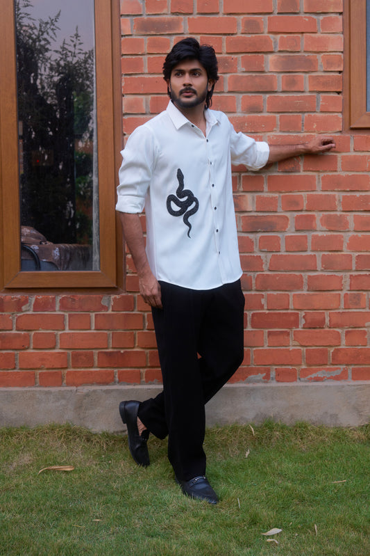 White shirt with a black snake hand embroidery design