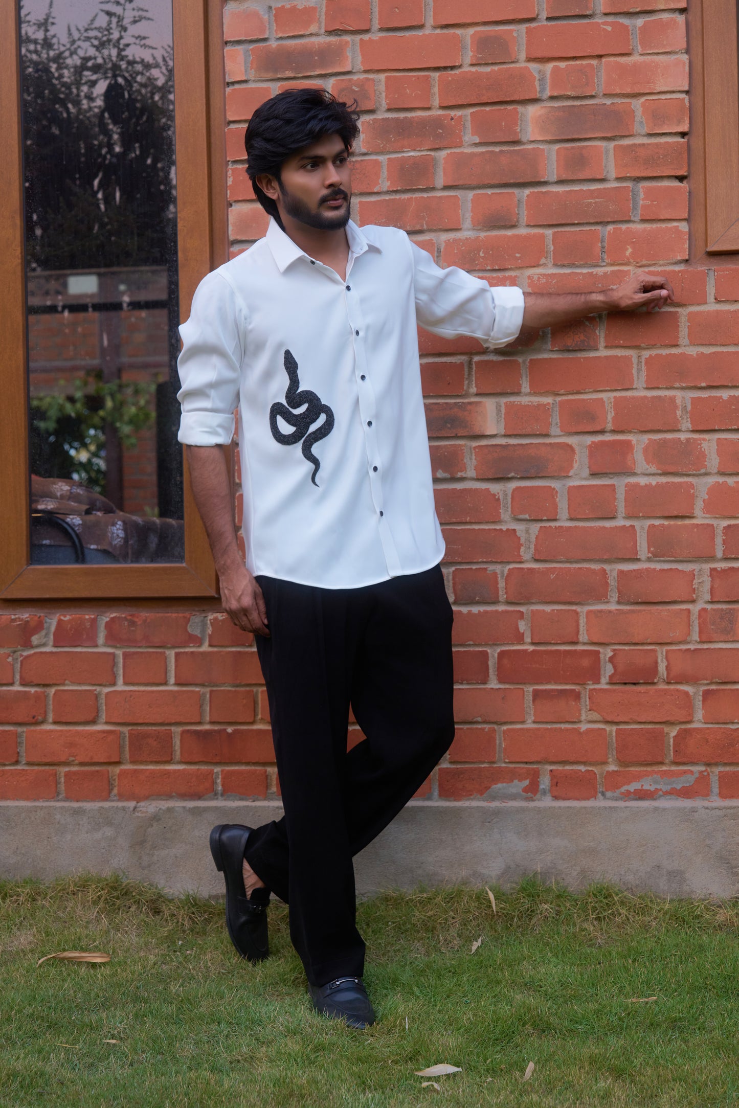 White shirt with a black snake hand embroidery design